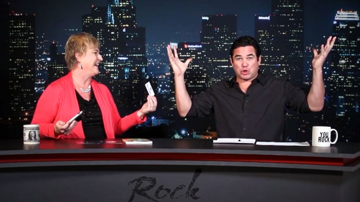 Image of Michelle Calloway on a TV set with Dean Cain as he demonstrates that his mind is blown away