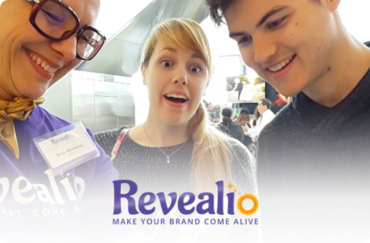 Image of Revealio staff showing AR technology to a bewildered couple